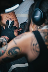 a woman getting a tattoo